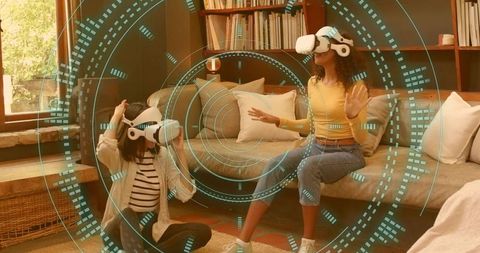 Two women wearing vr headsets experiencing futuristic holographic hud in living room