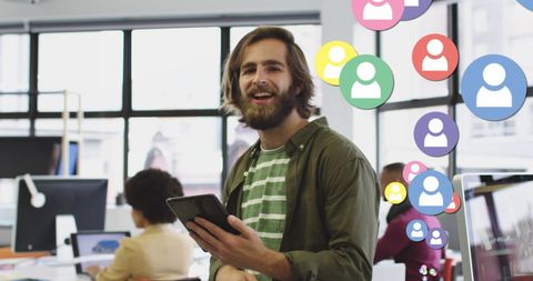 Smiling Businessman Engaging with Digital Network Icons in Office