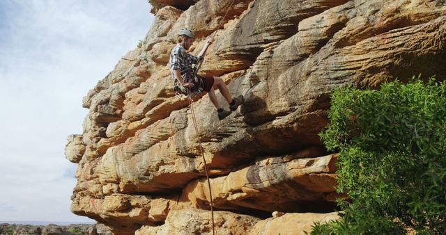 Adventurous Climber Rappelling Down Rocky Cliff - Download Free Stock Images Pikwizard.com