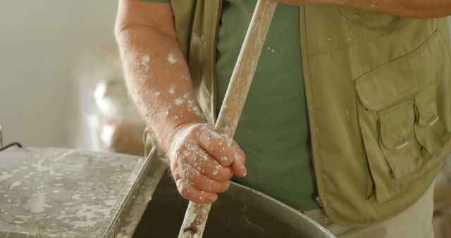 Close-up of Artisan Pouring Liquid into Large Vat - Download Free Stock Images Pikwizard.com