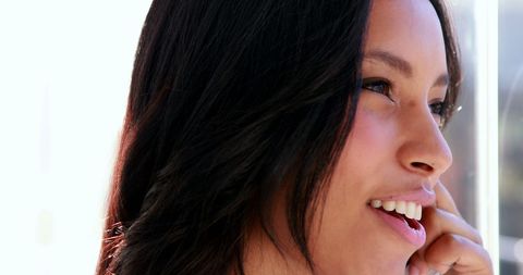 Confident businesswoman smiling on phone call at office desk