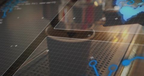 Futuristic transparent interface showing node network and digital globe over metal console