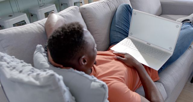 Relaxed Man Lying on Couch Using Laptop at Home - Download Free Stock Images Pikwizard.com