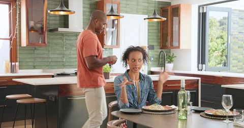 Couple Sharing Fun Dinner Moments in Kitchen