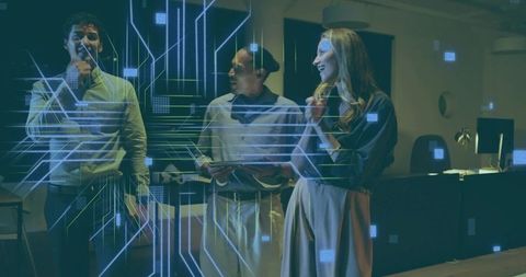 Team collaborating with holographic interface and tablet in futuristic office