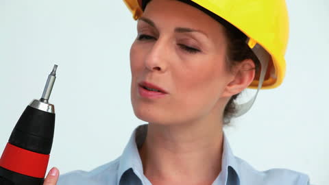 Focused Female Engineer Using Screw Gun