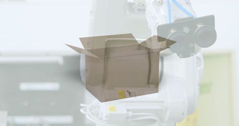 Automated robot handling cardboard box in warehouse