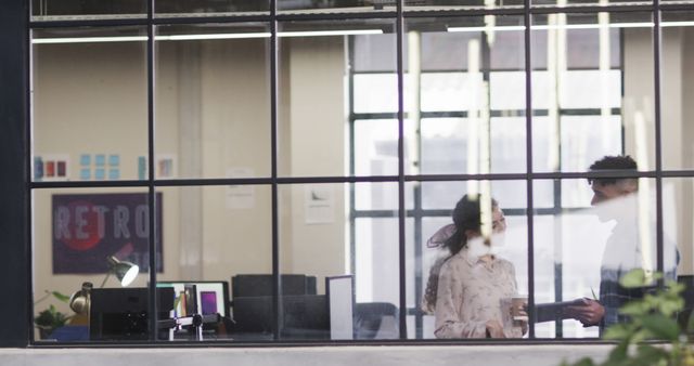 Colleagues Discussing Work in Modern Office Through Window - Download Free Stock Images Pikwizard.com