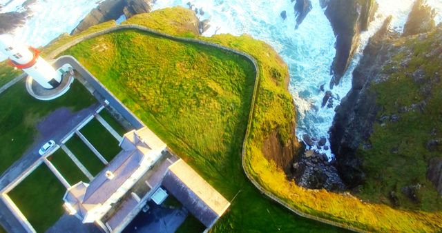Aerial View of Lighthouse on Rugged Coastline - Download Free Stock Images Pikwizard.com