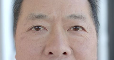 Mature man's face close-up showing skin texture and wrinkles