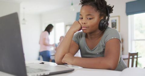 African American Girl Learning Online with Laptop at Home