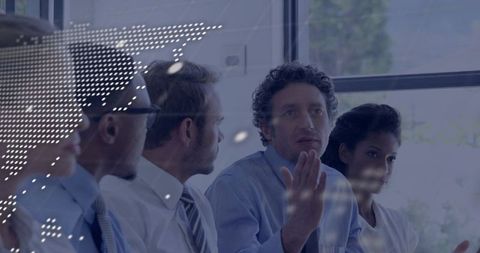 Business leader presenting in boardroom with engaged team and digital projection overlay