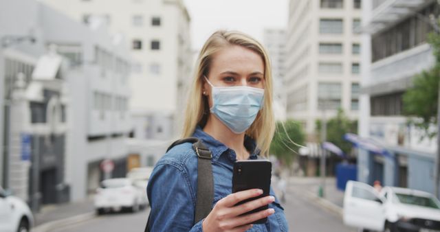 Woman Wearing Face Mask and Using Smartphone on City Street - Download Free Stock Images Pikwizard.com