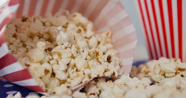 Tasty Popcorn Overflowing from Striped Box on Polka Dotted Surface - Download Free Stock Images Pikwizard.com