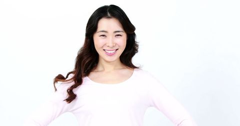 Smiling Asian Woman in Casual White Outfit against White Background