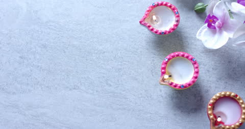 Diwali Candle Arrangement with Florals on Marble Surface