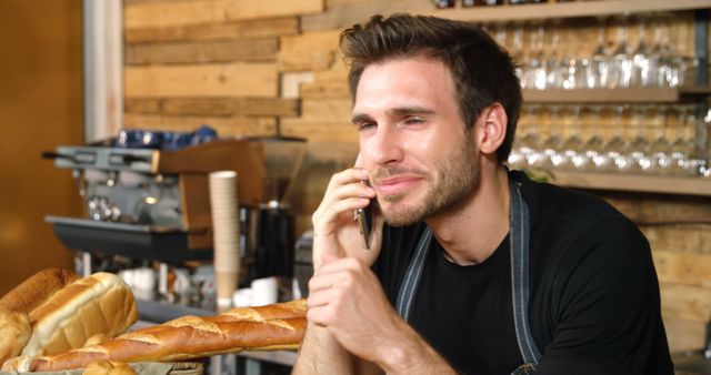 Smiling Young Barista Talking on Phone in Coffee Shop - Download Free Stock Images Pikwizard.com