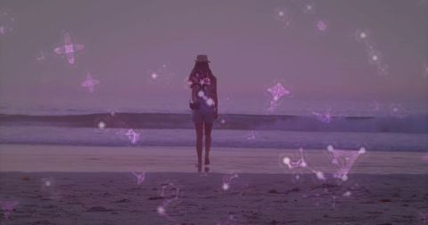 Woman Enjoying Dreamy Beach Sunset with Magical Purple Lights