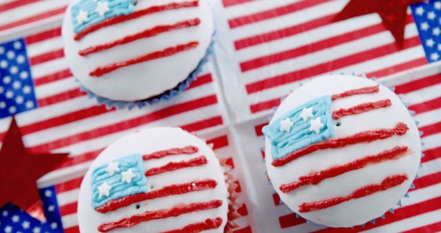 Cupcakes decorated with the American flag theme suggest a celebration of a patriotic holiday, with copy space. Festive treats like these are often seen during events such as the Fourth of July or Memorial Day.