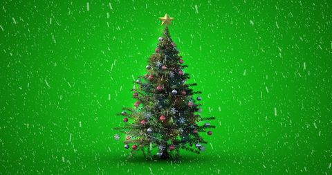 Decorated Christmas Tree with Falling Snow on Green Background