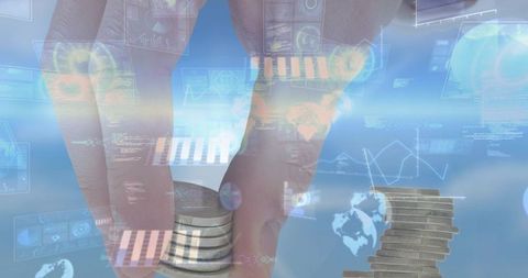 Hand placing coin stack on reflective surface with fintech hud showing analytics