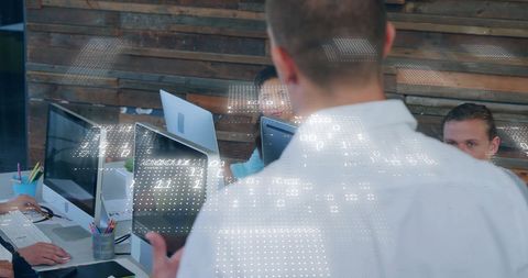 Tech Professionals Collaborating in Modern Office with Digital Data Overlay