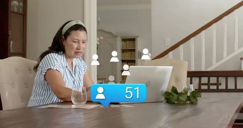 Woman working from home receiving 51 social notifications while concentrating on laptop