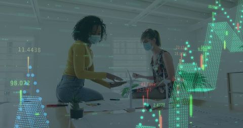 Colleagues Discussing Data in Office with COVID-19 Safety Precautions