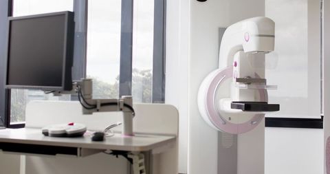 Modern digital mammography machine in bright breast imaging clinic room
