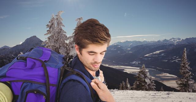 Young man with a backpack enjoying a peaceful winter hike in scenic snowy mountains. Perfect for travel blogs, outdoor adventure promotions, winter vacation advertisements, and nature-themed inspirations.