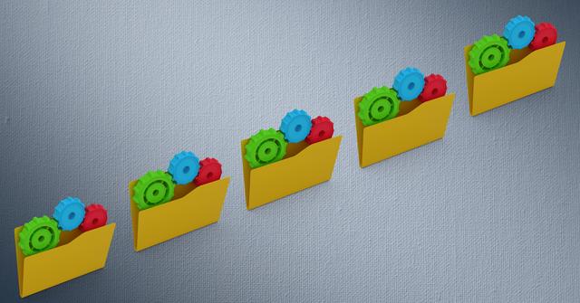 Digital illustration shows four yellow file folders filled with red, blue, and green gears arranged in a row against a textured grey background. Perfect for business, technology, industrial systems, and organizational themes. Can be used in presentations, blogs, and articles related to data management and process optimization.