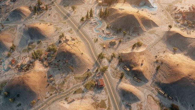 Winding two-lane road cutting diagonally through sunlit arid hills with pools and walkways