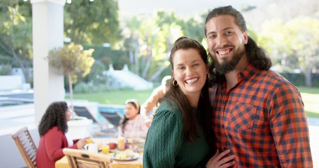 Couple Smiling at Outdoor Family Gathering on Patio - Download Free Stock Images Pikwizard.com