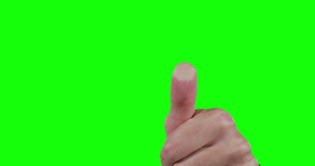 A Caucasian hand is giving a thumbs up against a green screen background, with copy space. Gestures like this are commonly used to signify approval or a job well done.