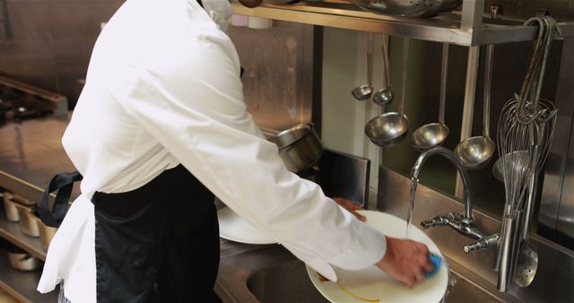 Restaurant Worker Washing Dishes in Commercial Kitchen - Download Free Stock Images Pikwizard.com