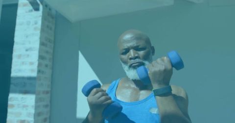 Mature Man Exercising with Dumbbells for Fitness and Strength at Home