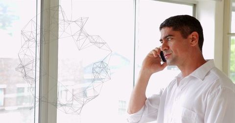 Professional Businessman Communicating on Smartphone in Modern Office
