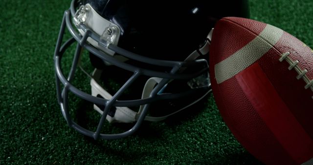 Close-up of Football Helmet and Ball on Field - Download Free Stock Images Pikwizard.com