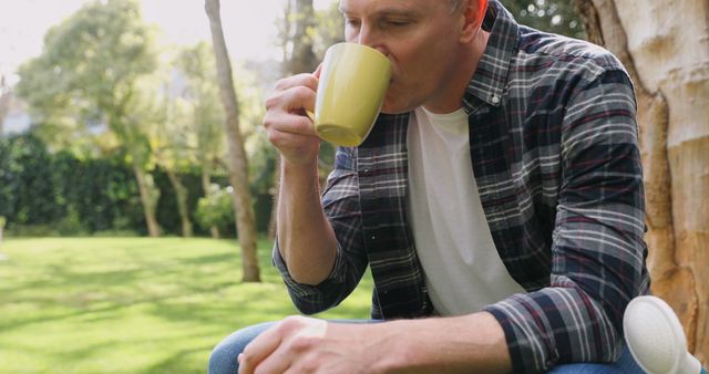 Man Relaxing Outdoors with Coffee Mug in Park - Download Free Stock Images Pikwizard.com