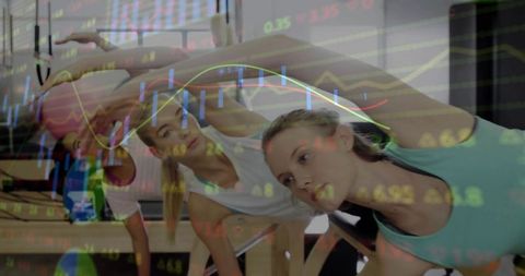 Women practicing pilates with stock market visual overlay
