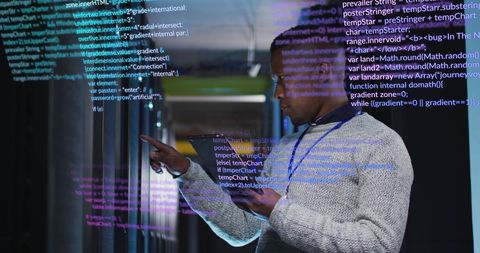 Engineer Analyzing Data on Digital Tablet in Modern Server Room - Download Free Stock Images Pikwizard.com