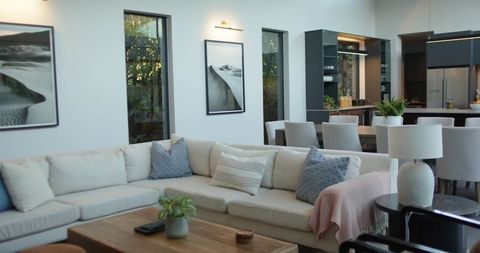 Cream Sectional Anchoring Open-Plan Living and Dining Room with Blue Accent Pillows