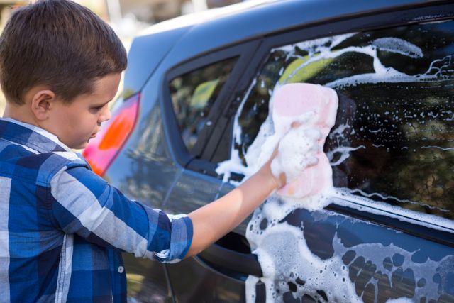Teenage boy washing a car - Download Free Stock Photos Pikwizard.com