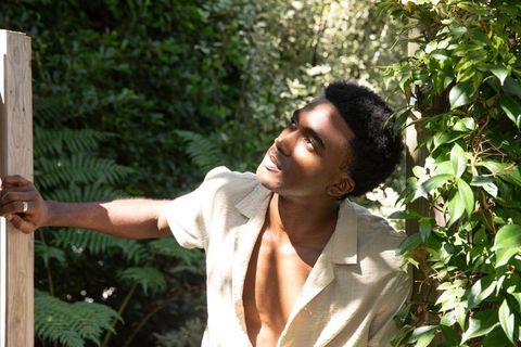 African American Man in Garden Sunlit by Golden Hour