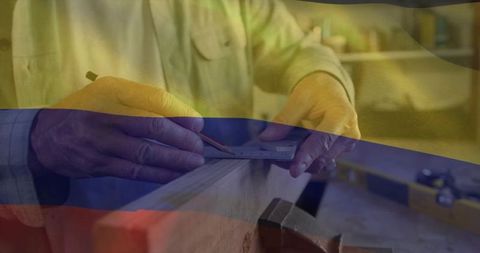 Carpenter Marking Lumber with Combination Square in Workshop