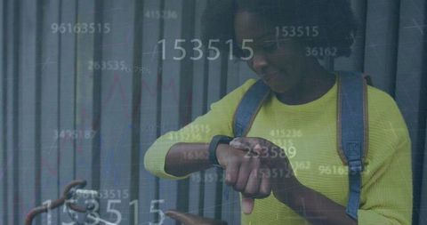 African American Woman Using Smartwatch with Data Overlay