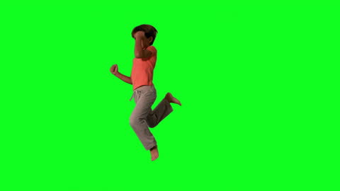 Energetic Boy Jumping in Mid-Air on Green Screen