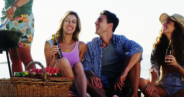 Friends Having Picnic at Beach, Smiling and Enjoying Drinks - Download Free Stock Images Pikwizard.com