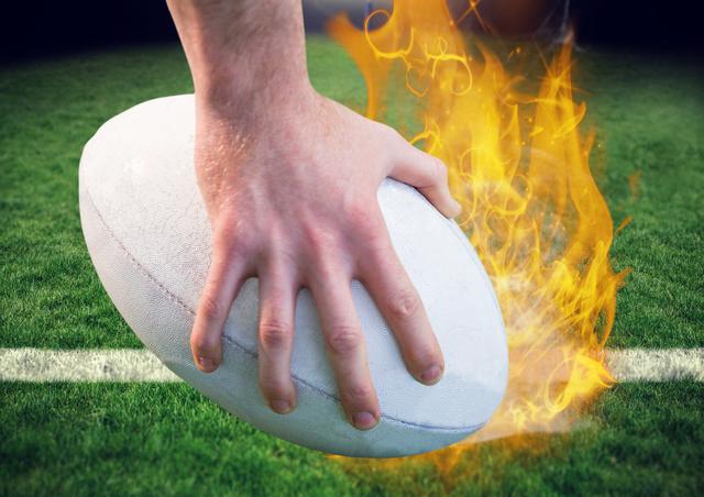 Dramatic depiction of a rugby player holding a ball that has flames on a stadium pitch. Ideal for illustrating intense sports scenes, dynamic competition concepts, and promoting rugby events. Can be used in advertisements and marketing materials related to rugby or sports events.