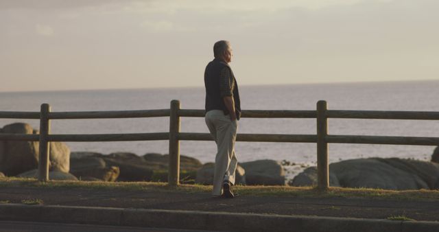 Elder man contemplating by the ocean at sunrise - Download Free Stock Images Pikwizard.com